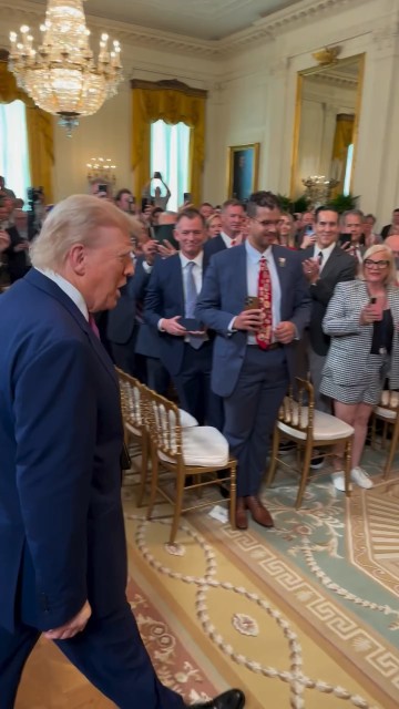 President Trump arrives in the East Room to sign a congressional resolution