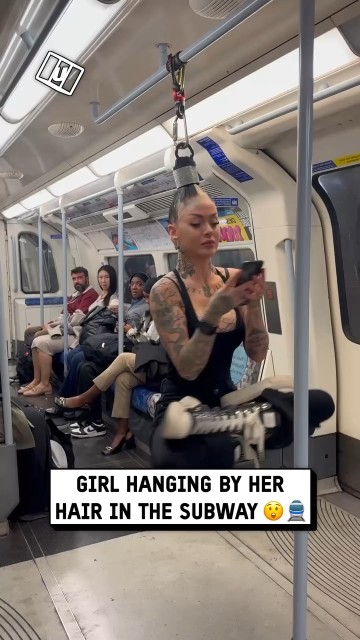 Girl hanging by her hair in the subway