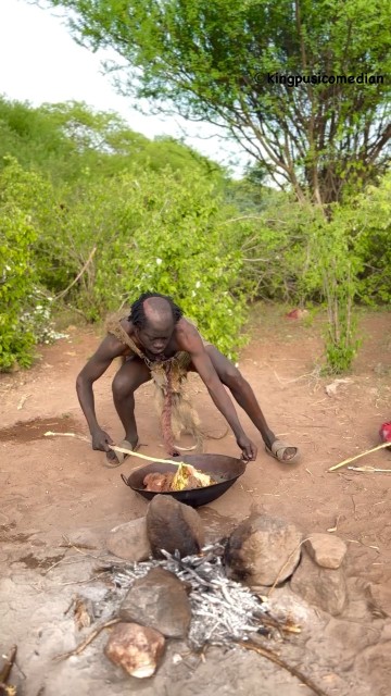 “A member of the Hadzabe eating a meal.